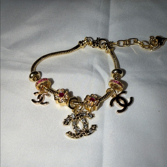 CHANEL Jewelry - CHANEL Gold and Pink Charm Bracelet